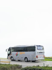 A gray tour bus parked on a road.