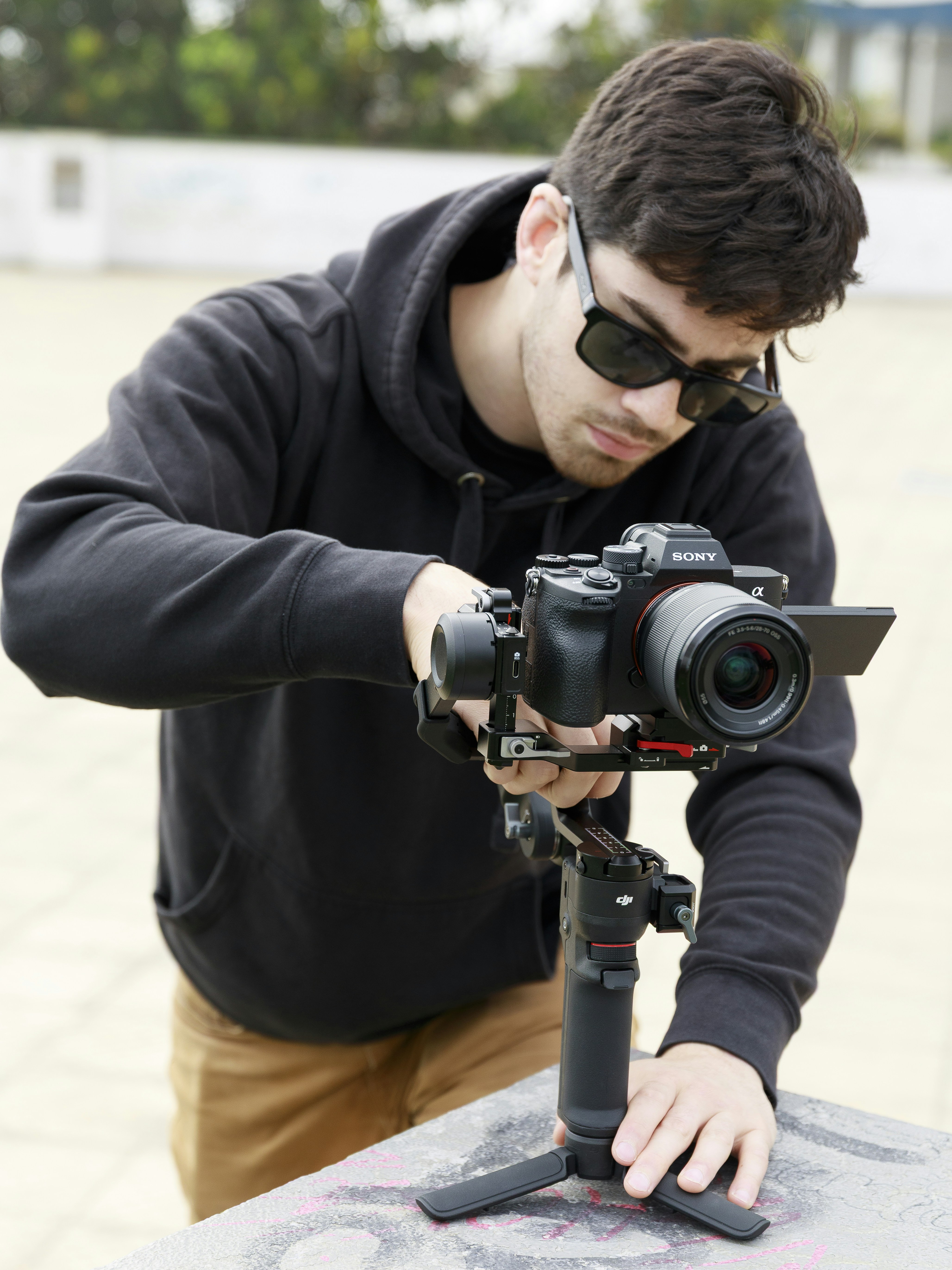 Man adjusting professional camera on a gimbal stabilizer