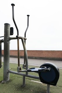 Outdoor elliptical exercise machine on green turf