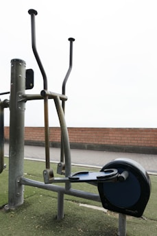 Outdoor elliptical exercise machine on green turf