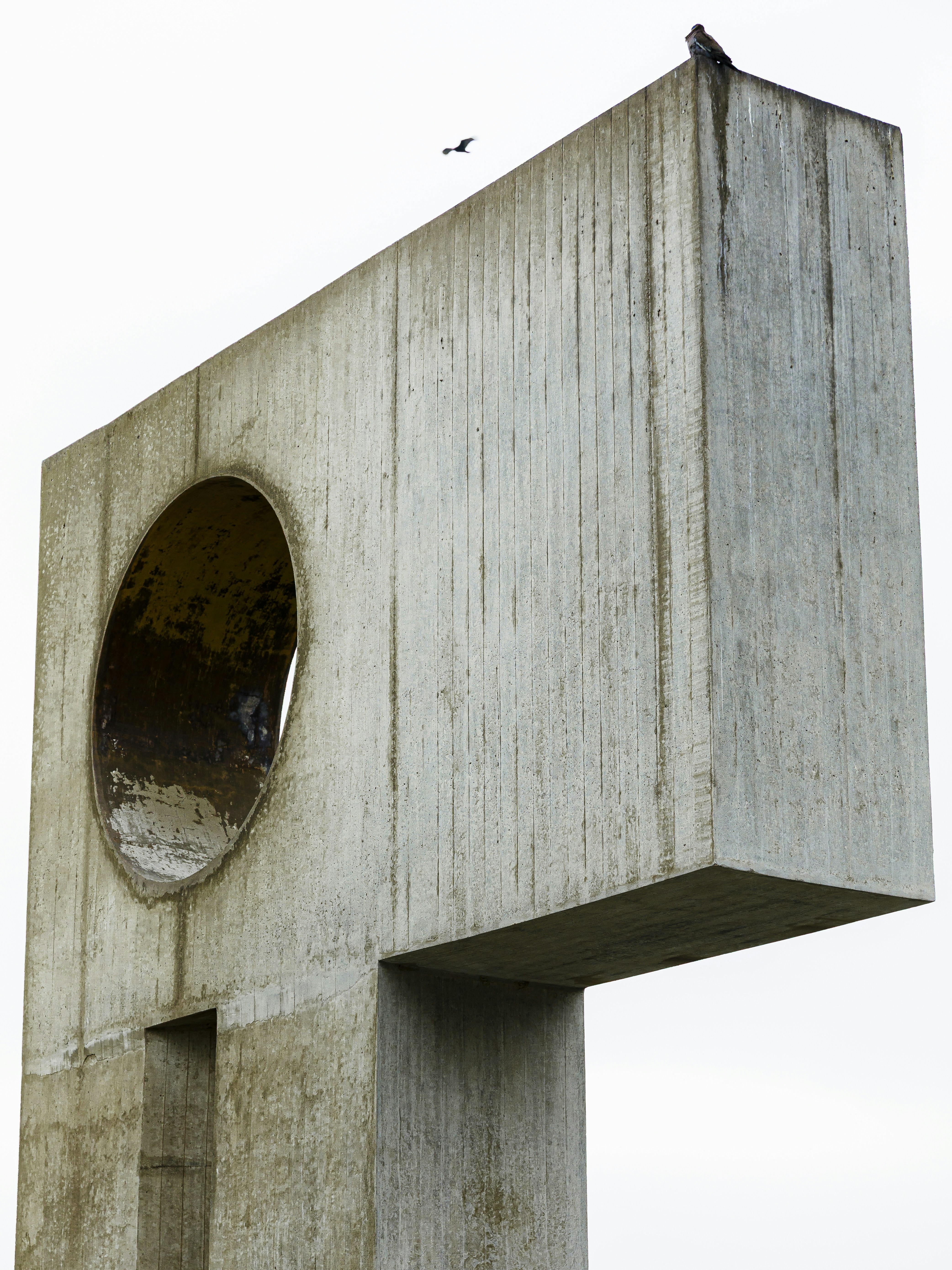 Concrete sculpture with a circular opening and bird
