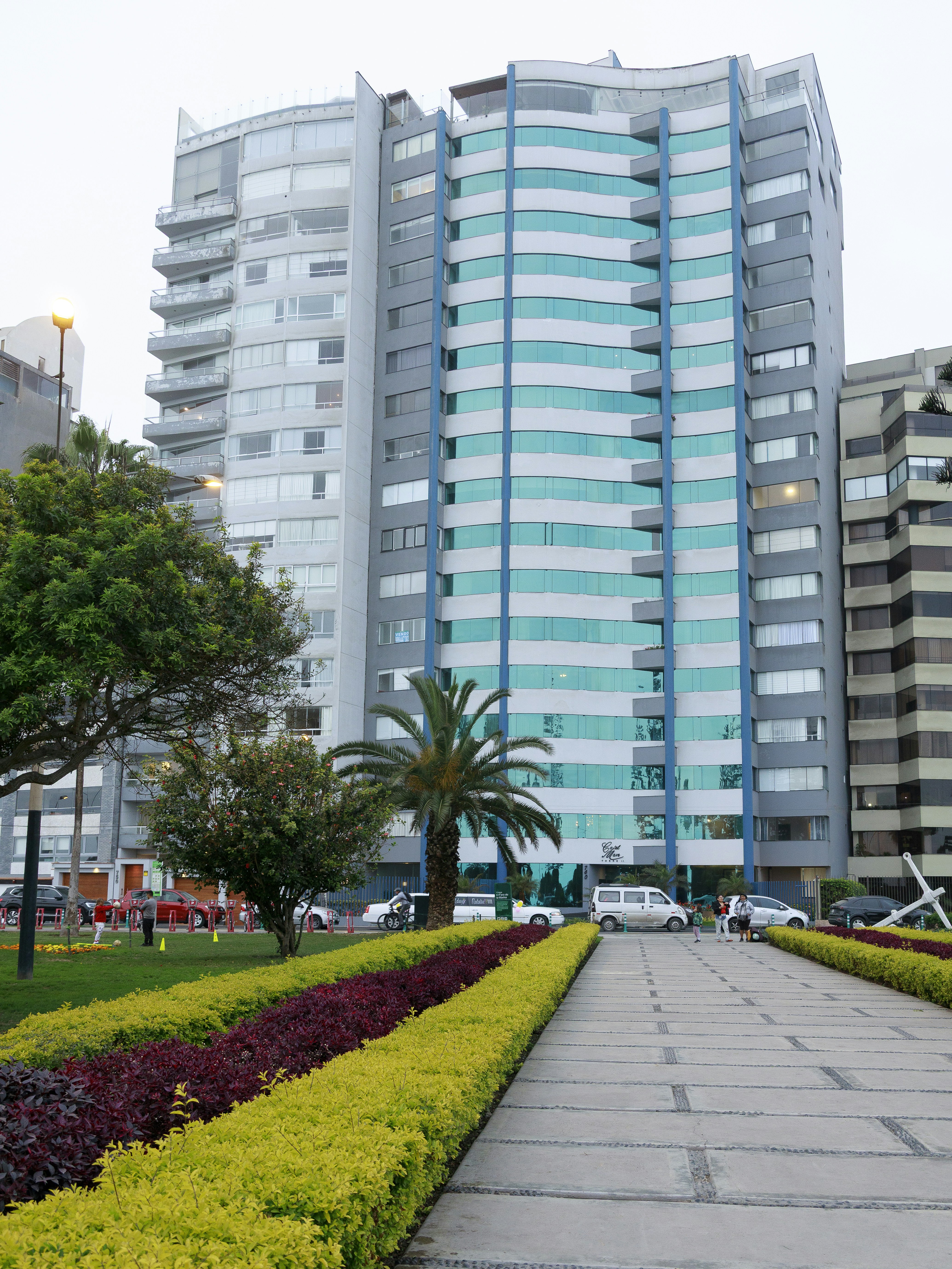 Modern high-rise building with blue and white balconies.