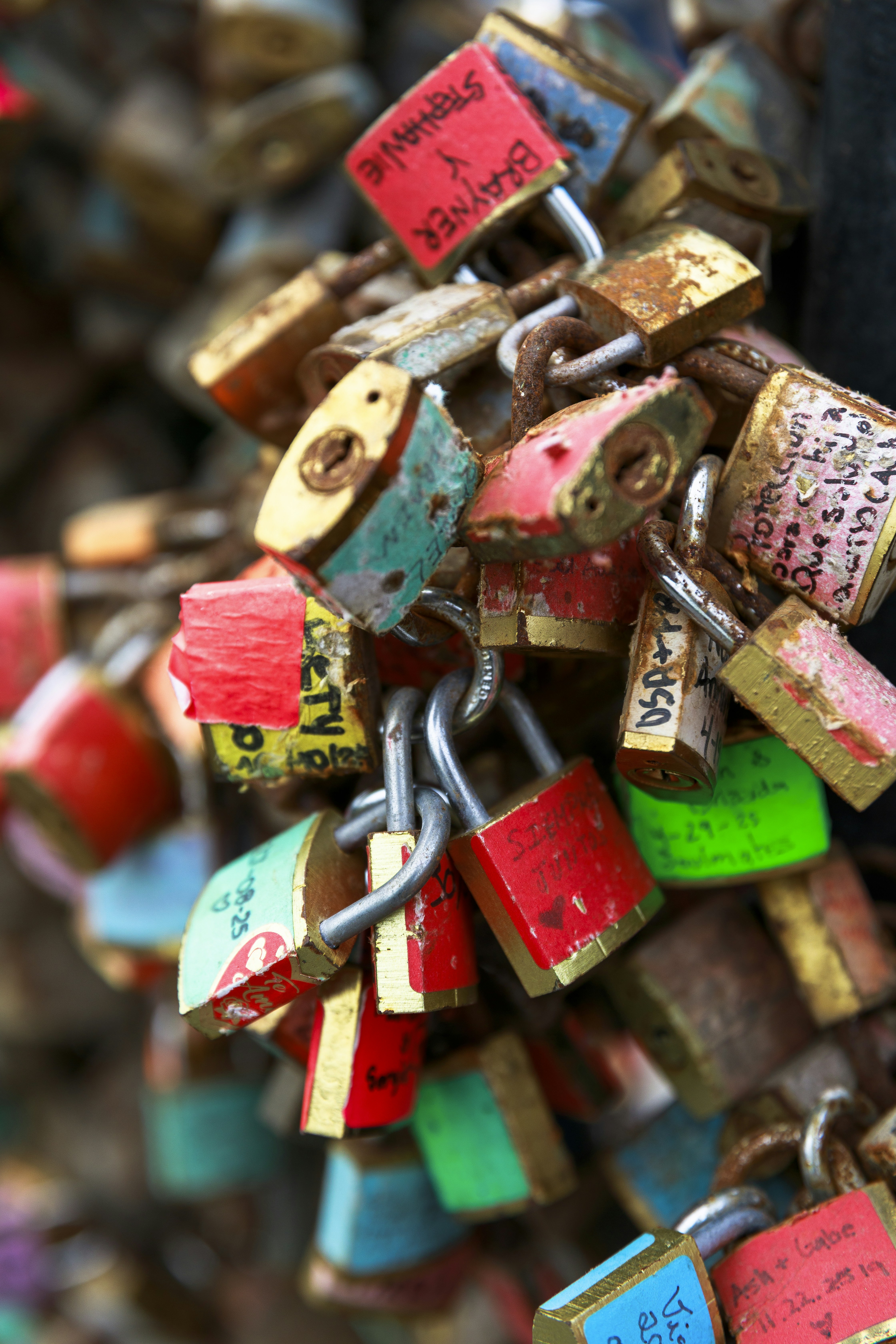 A cluster of colorful love locks attached to a chain.