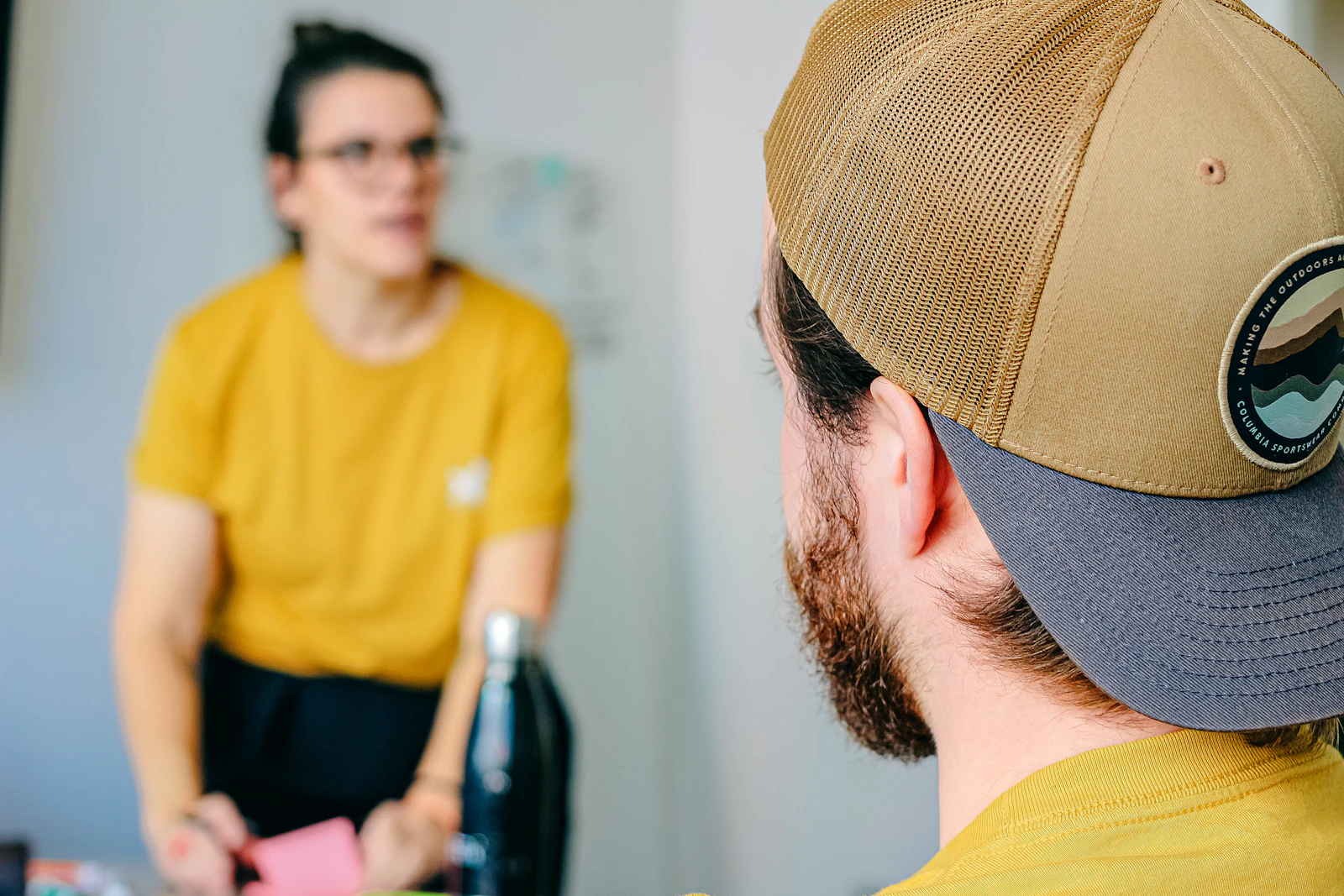 Two people in a focused one-to-one conversation across a table
