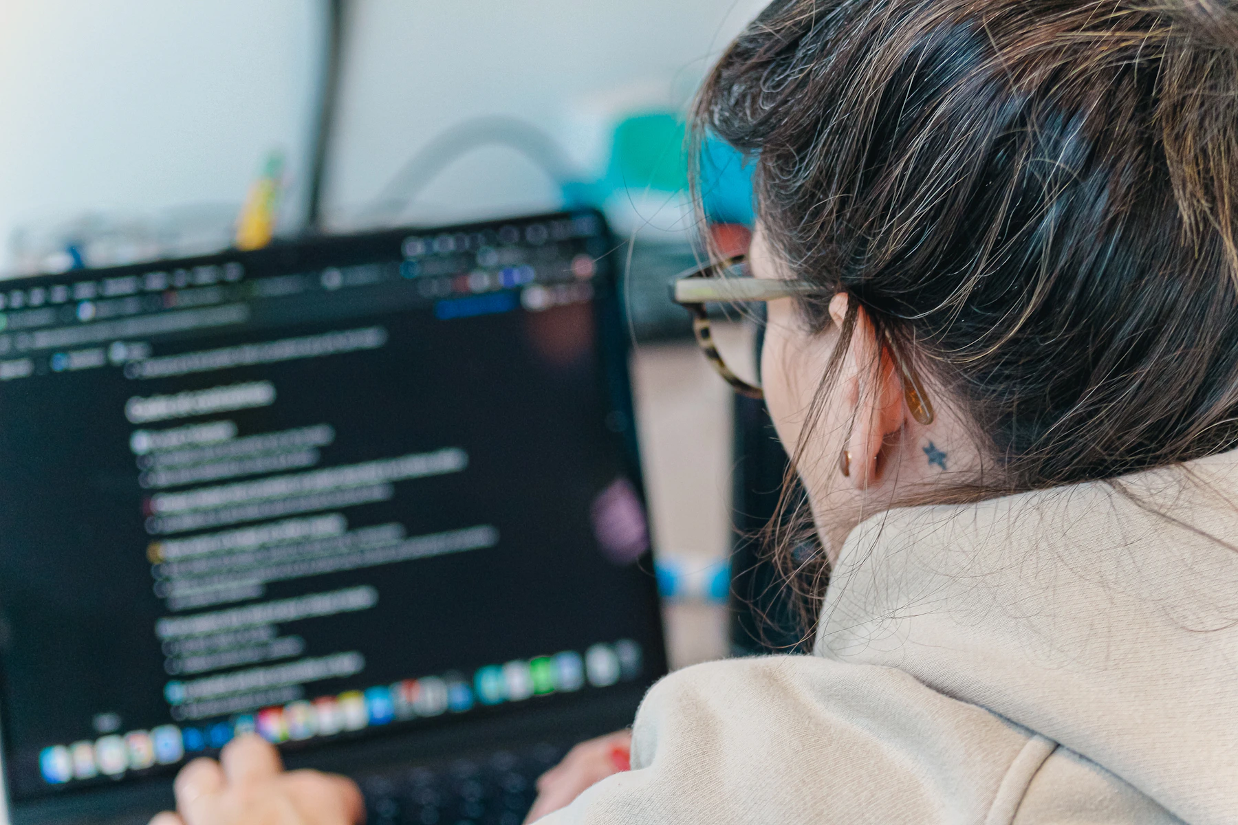 Technology professional working with software on a laptop