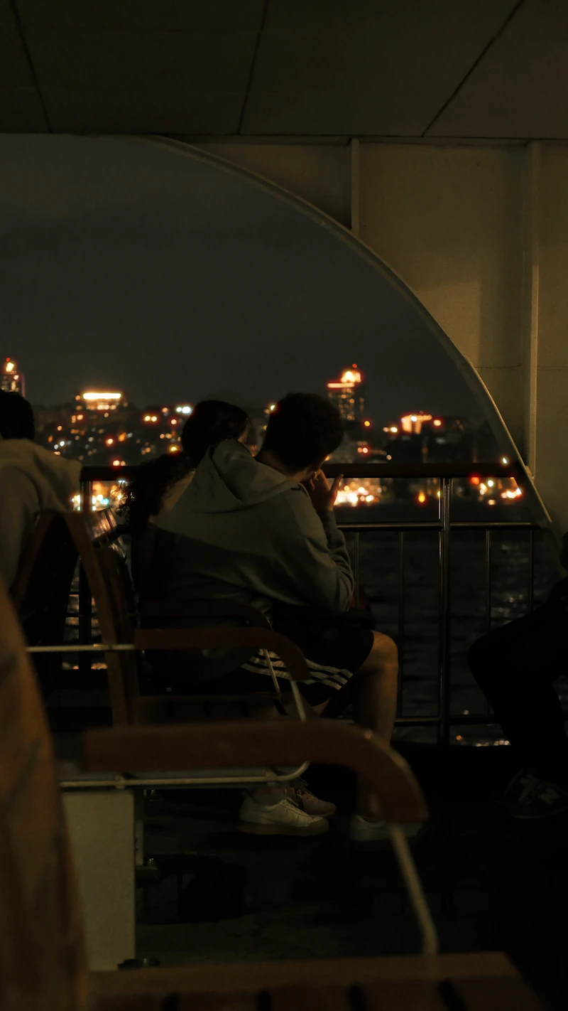 Couple enjoying a romantic evening on a boat at night
