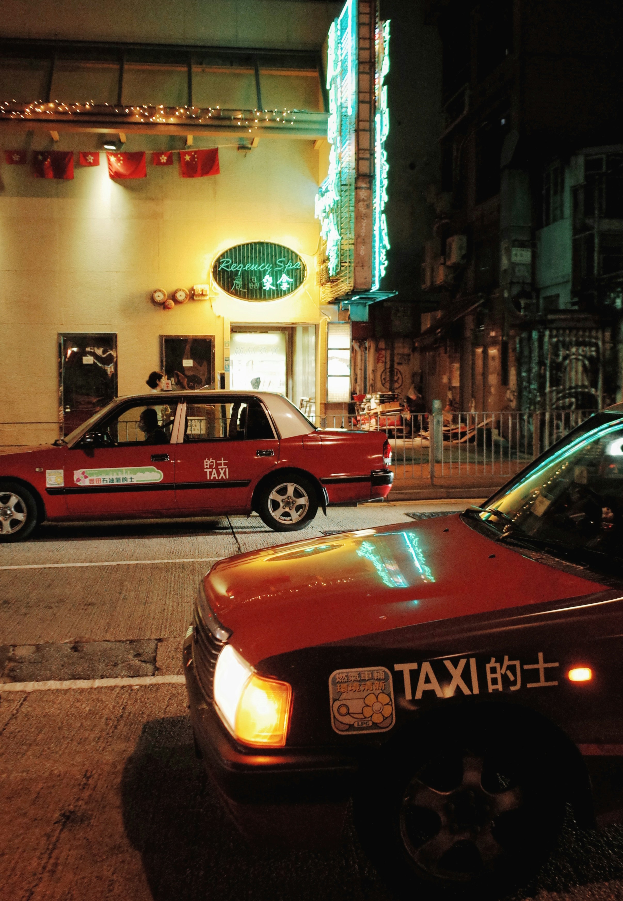Image of different types of taxis at a bustling city street