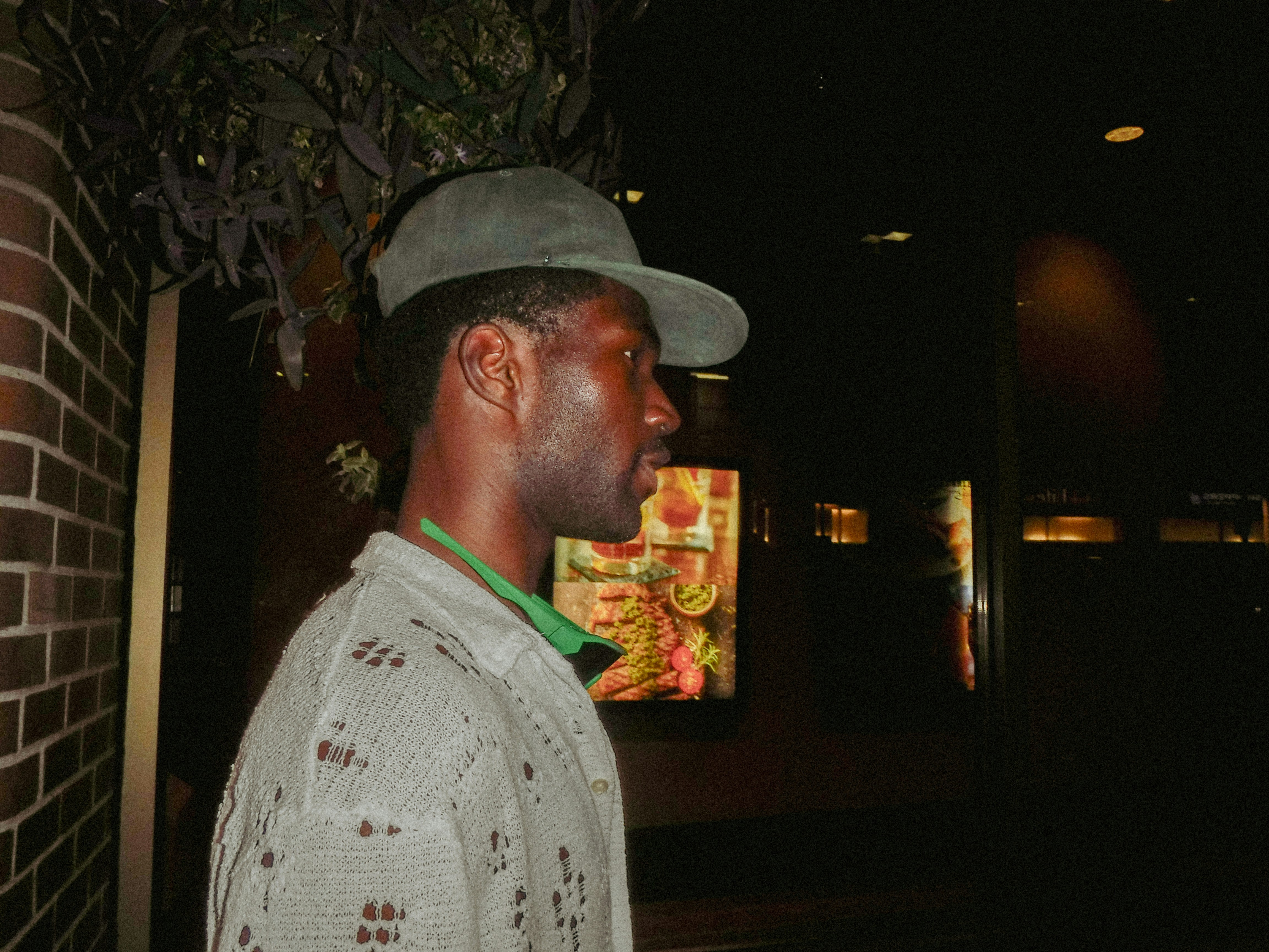 Man wearing a hat and shirt at-shirt at night