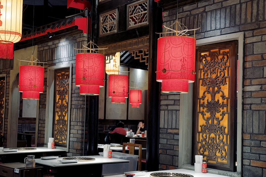 Red lanterns hang in a restaurant dining area.