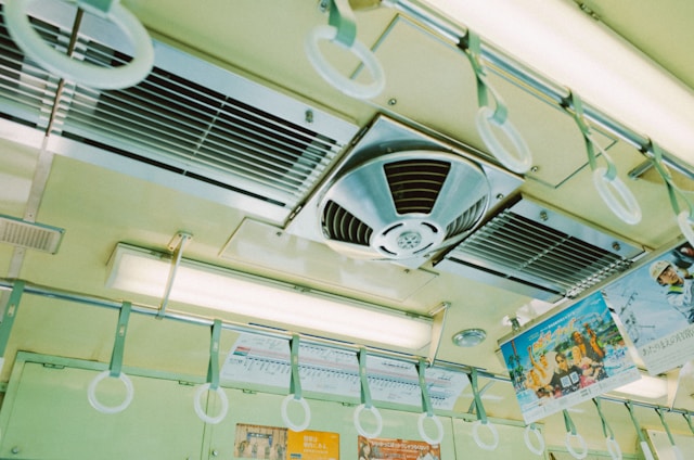 Interior view of a train ceiling with vents and handles