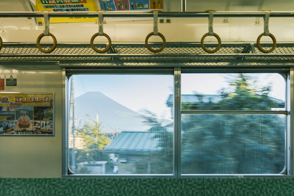 View of Mount Fuji from inside a train window on the ride toward Hakone