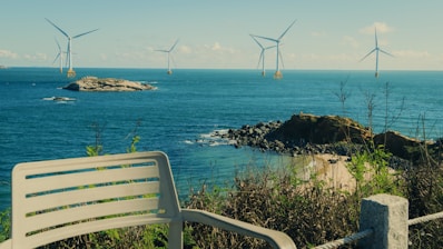 Offshore wind turbines in the blue ocean.