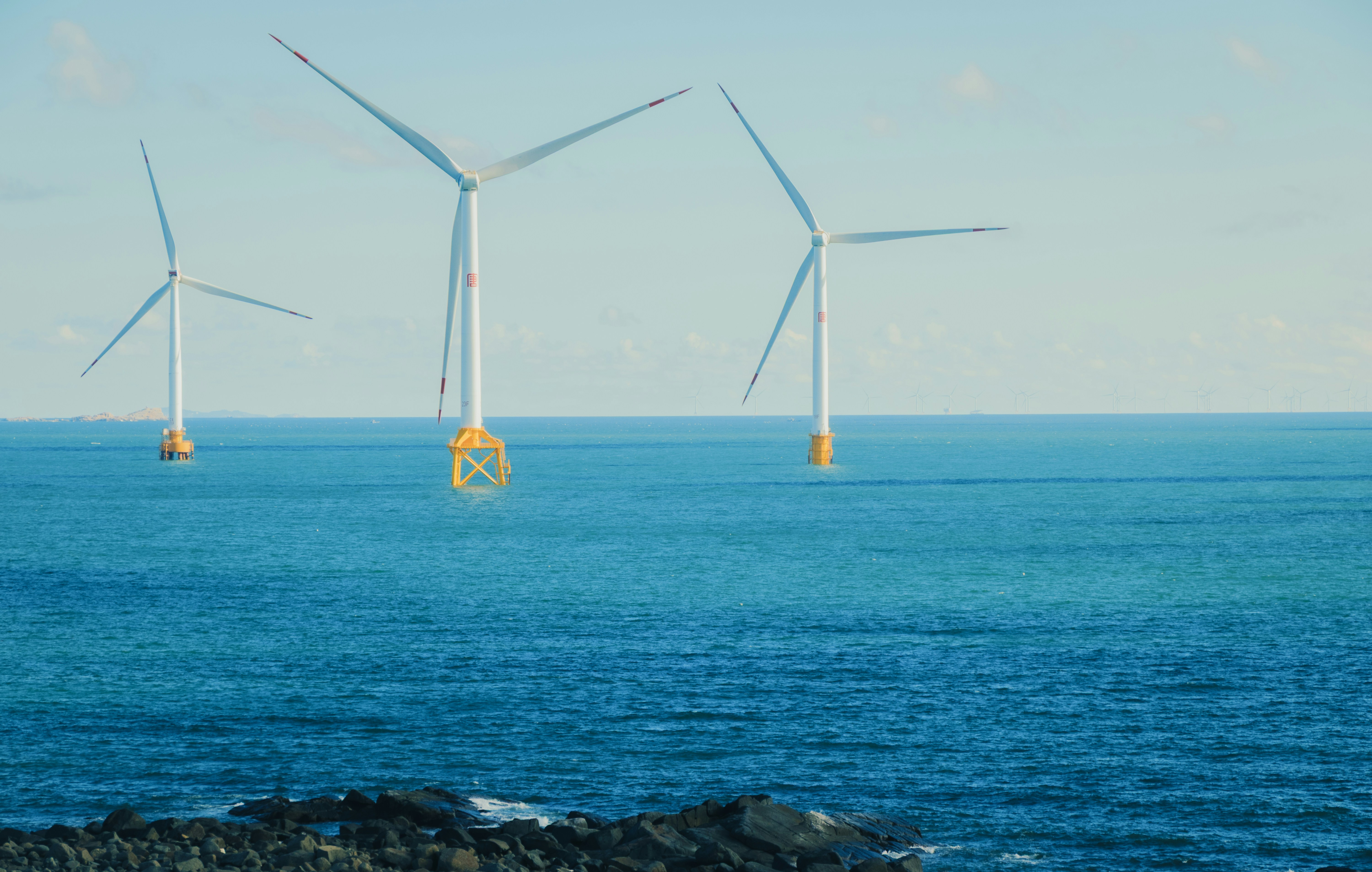 Wind turbines in the ocean on a clear day