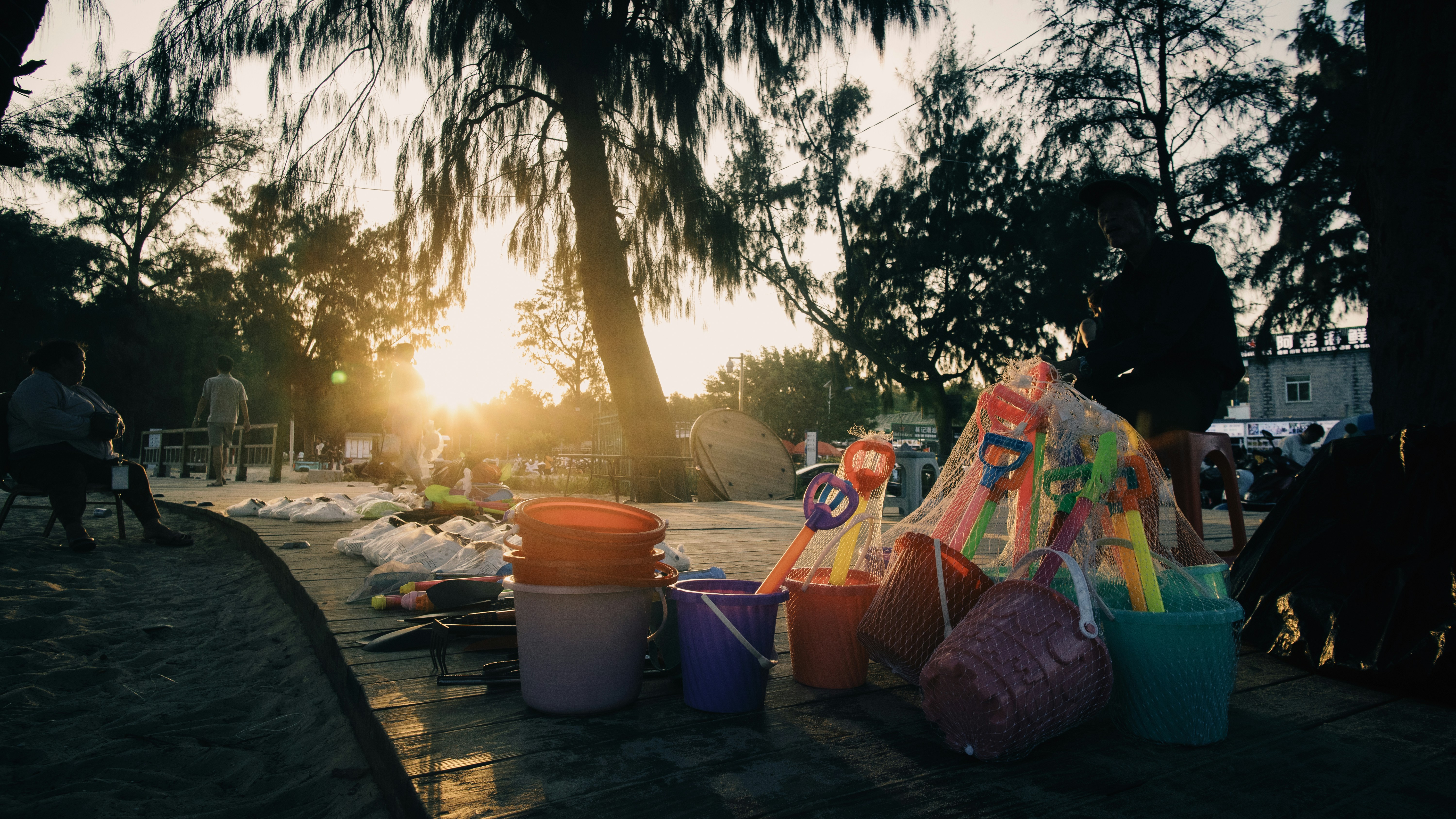 Sunset over a beach with buckets and bags
