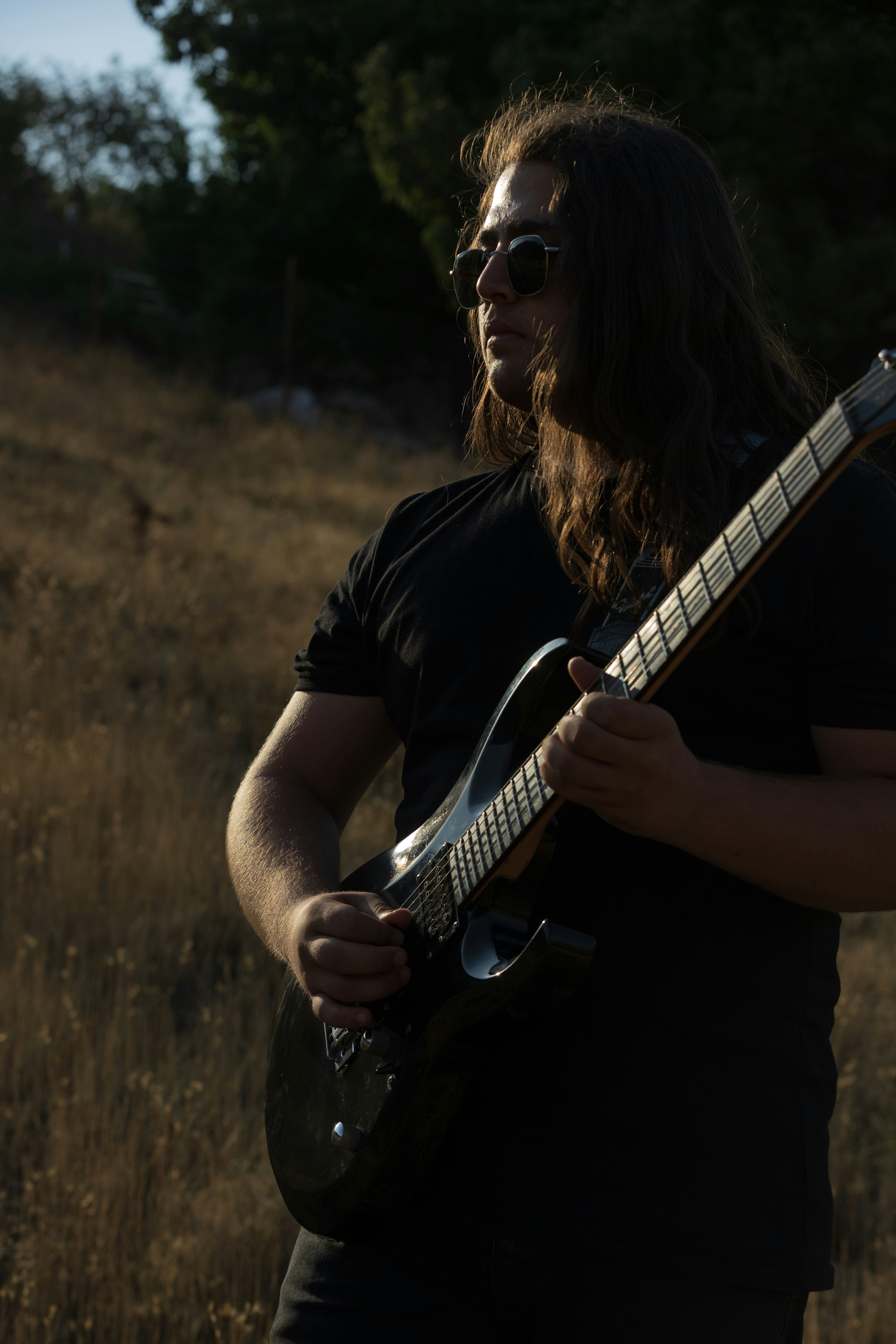 Man playing electric guitar outdoors