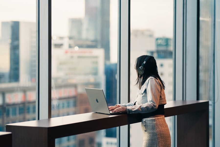 A property professional working at a window overlooking the city before the day begins.