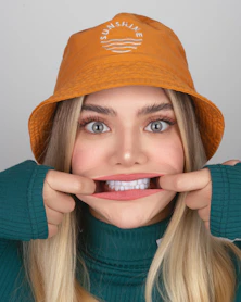 Woman pulls her cheeks to make a funny face.