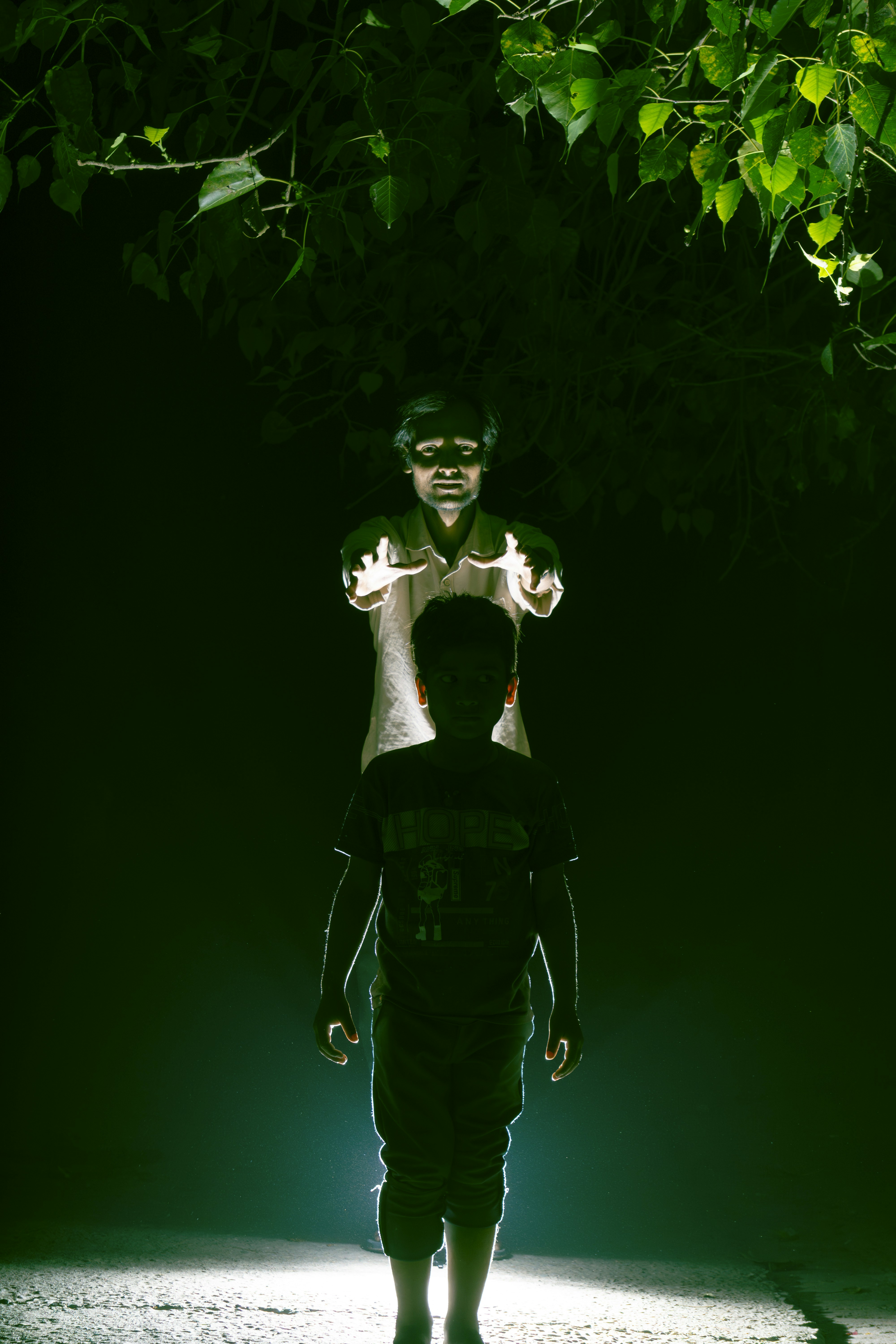 Two figures illuminated by light in the dark