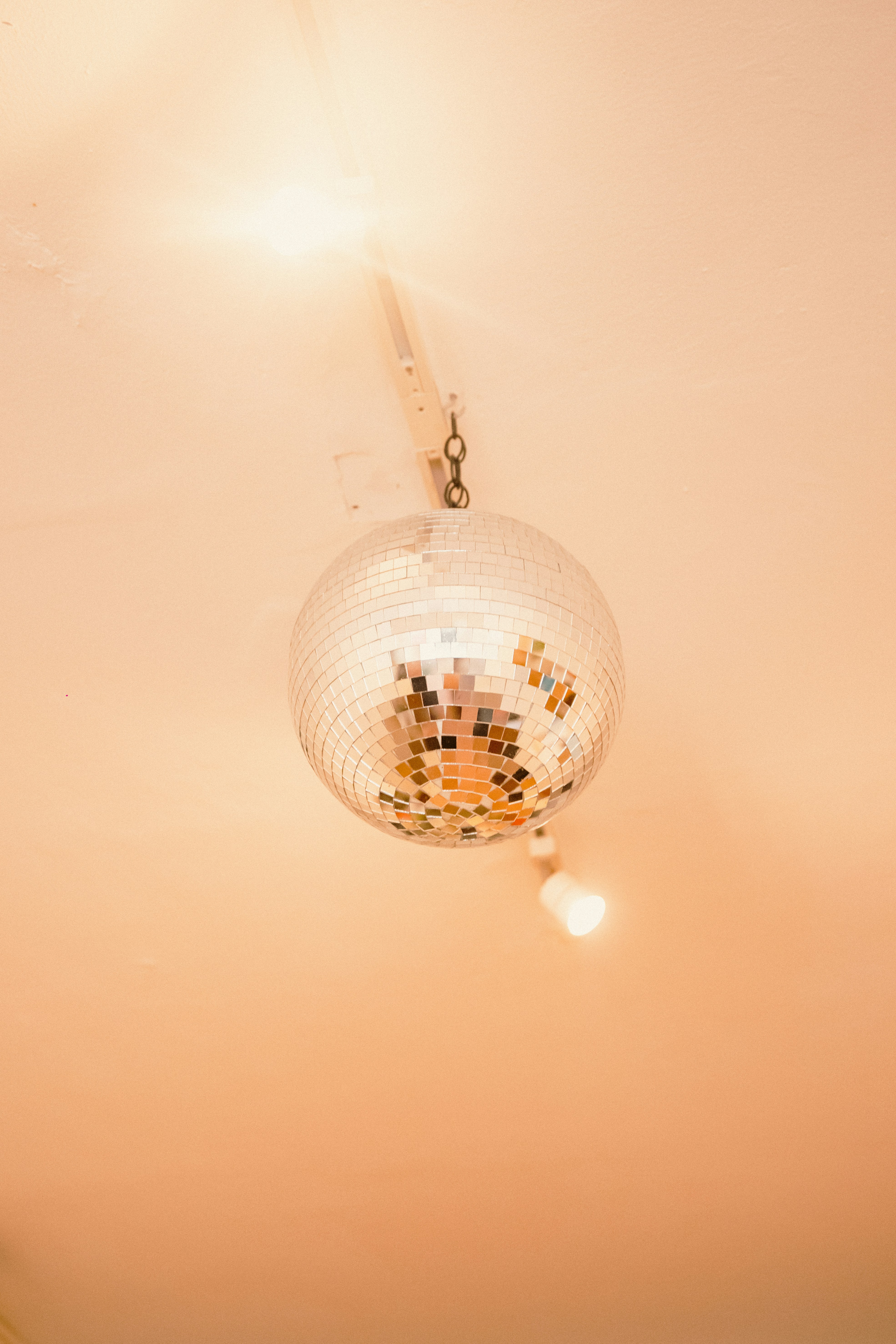A disco ball hangs from a chain.
