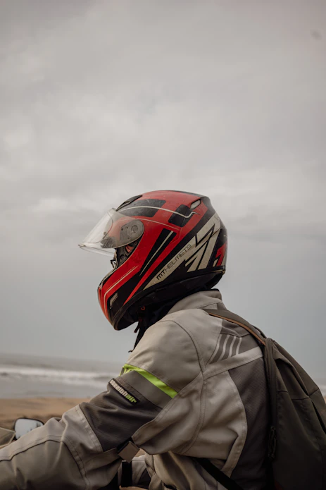 Person wearing a red motorcycle helmet and jacket