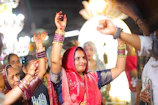 Women dancing with raised hands at a celebration.