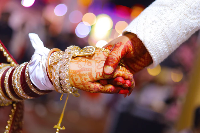 Bride and groom holding hands during a wedding ceremony | ProShoot.io
