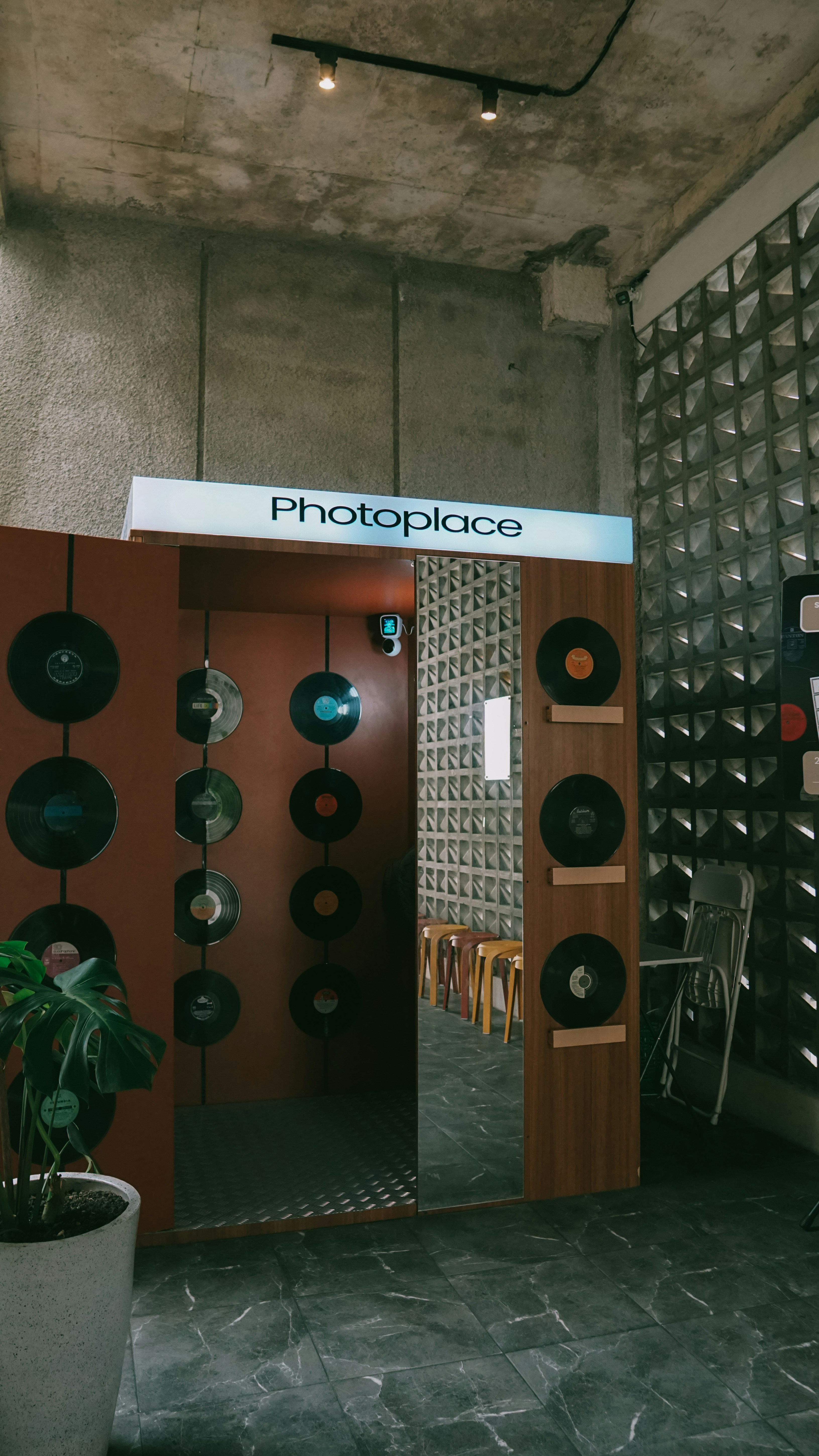 Entrance to a photo booth decorated with records
