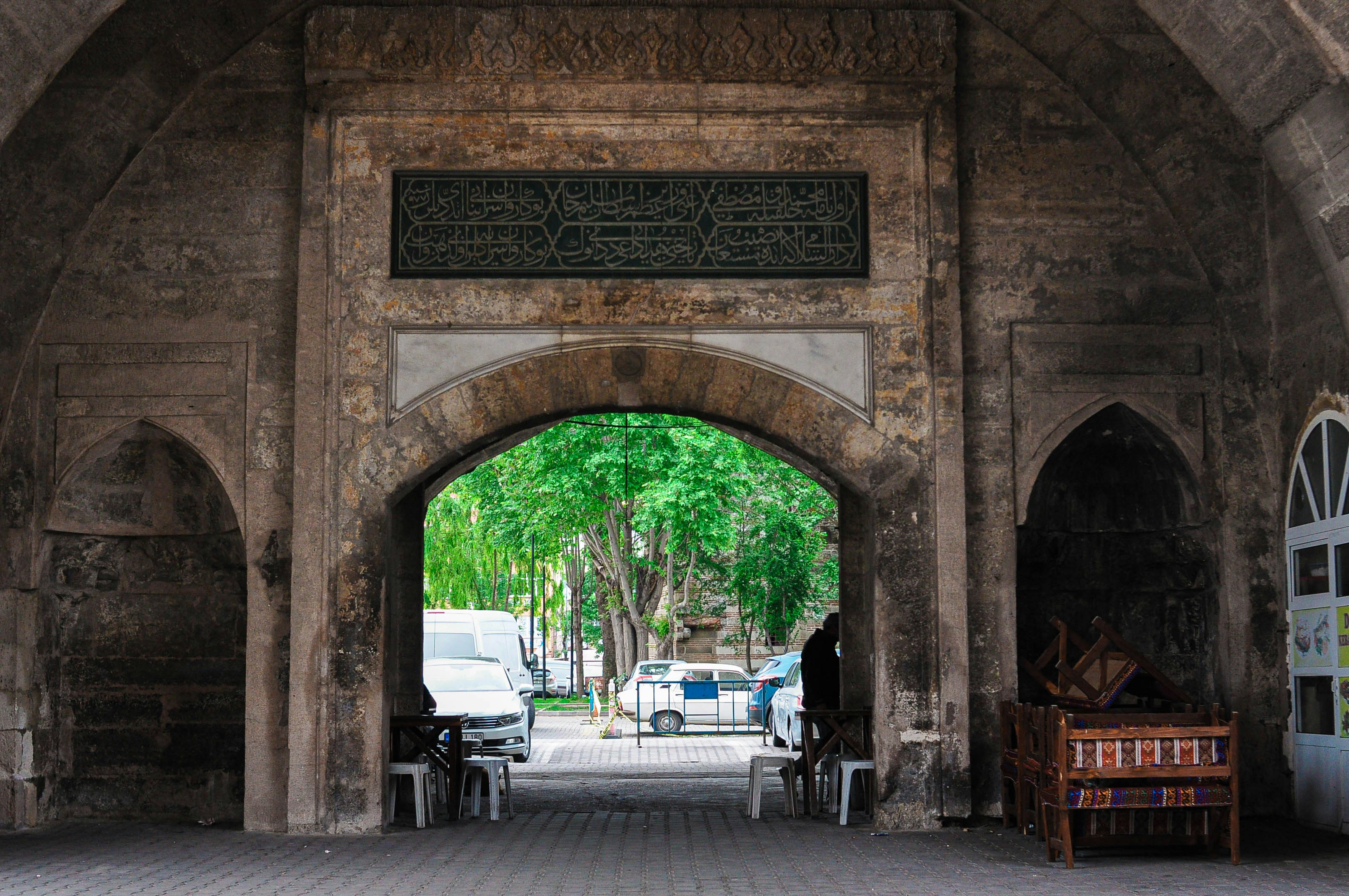 Arched stone gateway with trees visible beyond
