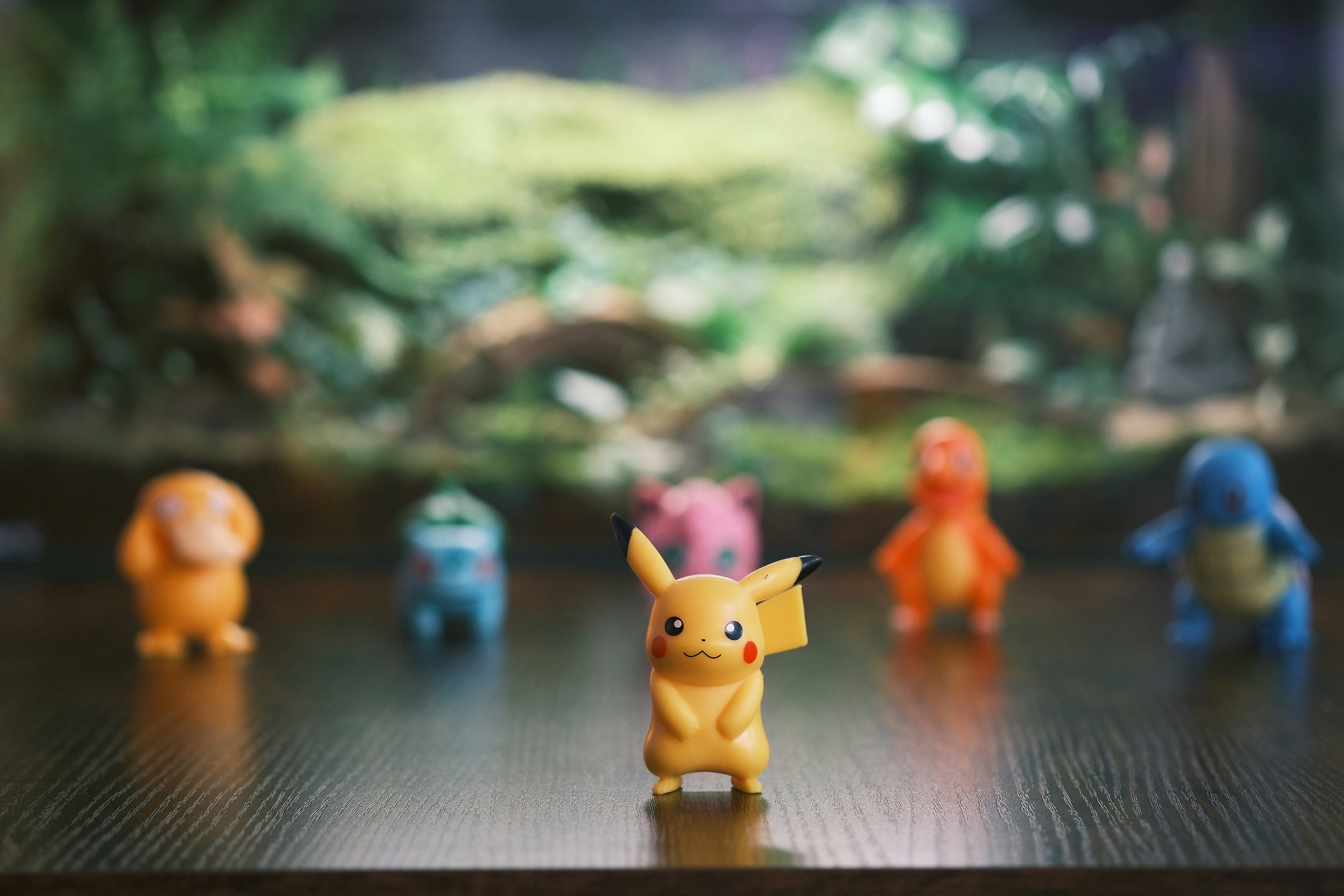 Pikachu and other pokemon figures on a table.