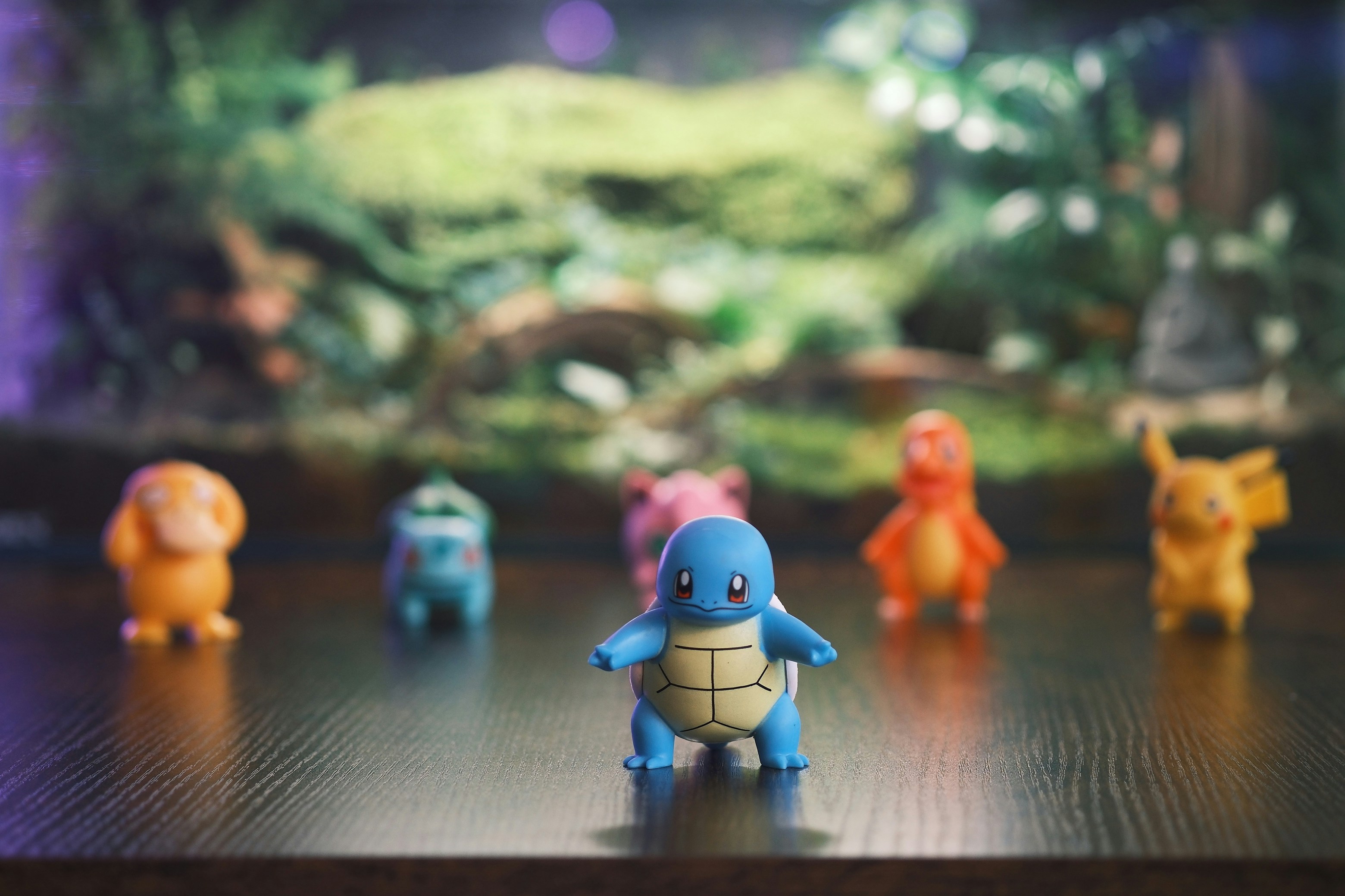 Several pokemon figurines arranged on a surface.