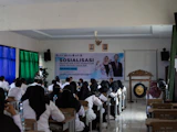 People attending a presentation or seminar indoors.