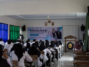 People attending a presentation or seminar indoors.
