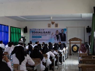 People attending a presentation or seminar indoors.