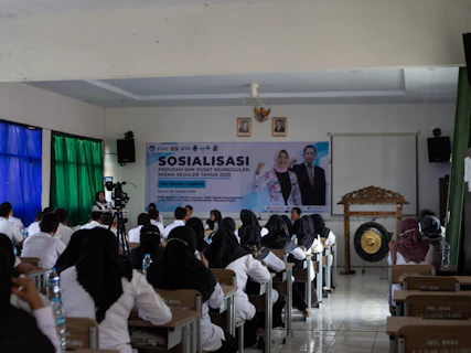 People attending a presentation or seminar indoors.