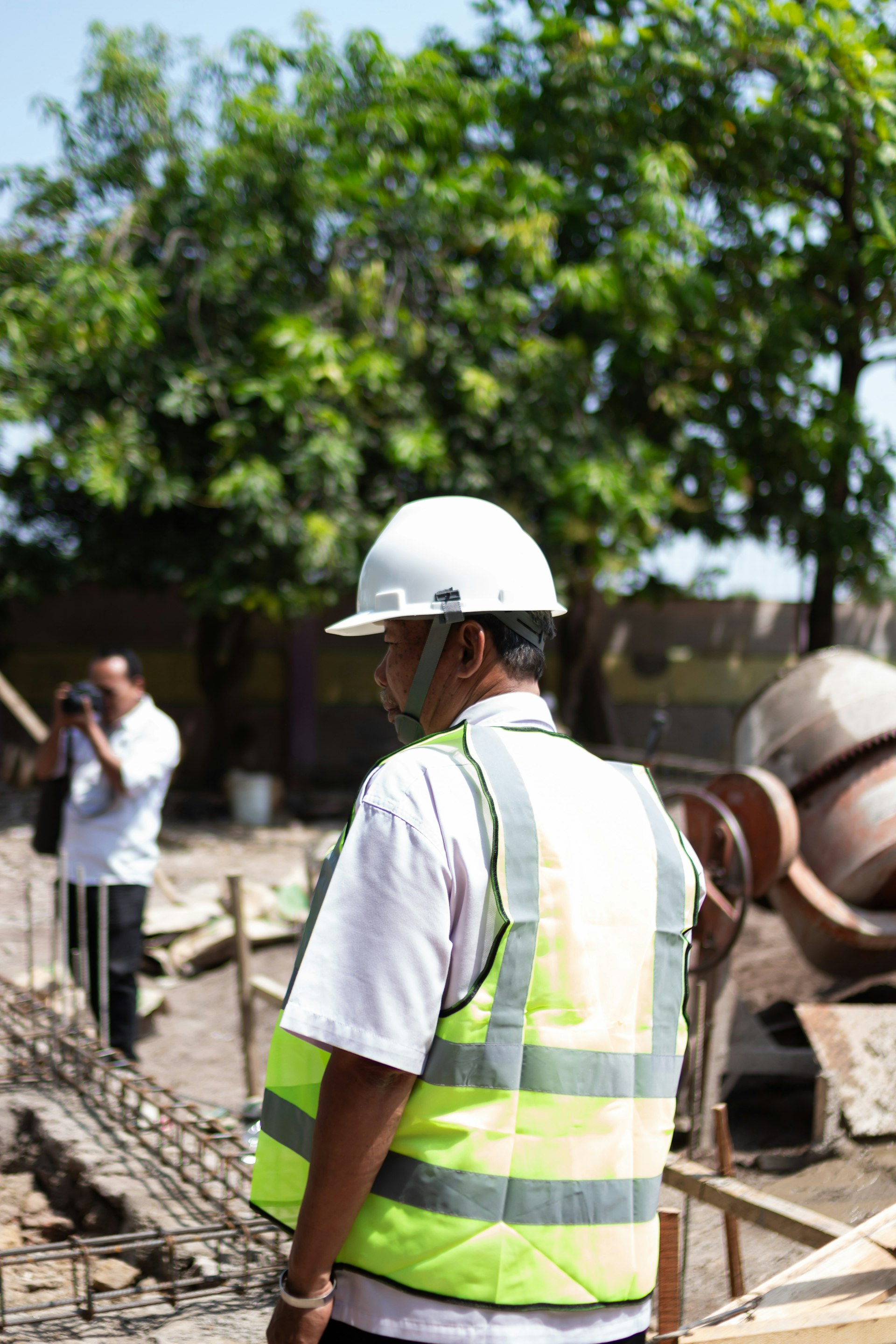 Construction worker wearing hard hat and hi-vis safety vest on jobsite