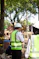Workers in hard hats and safety vests at construction site.