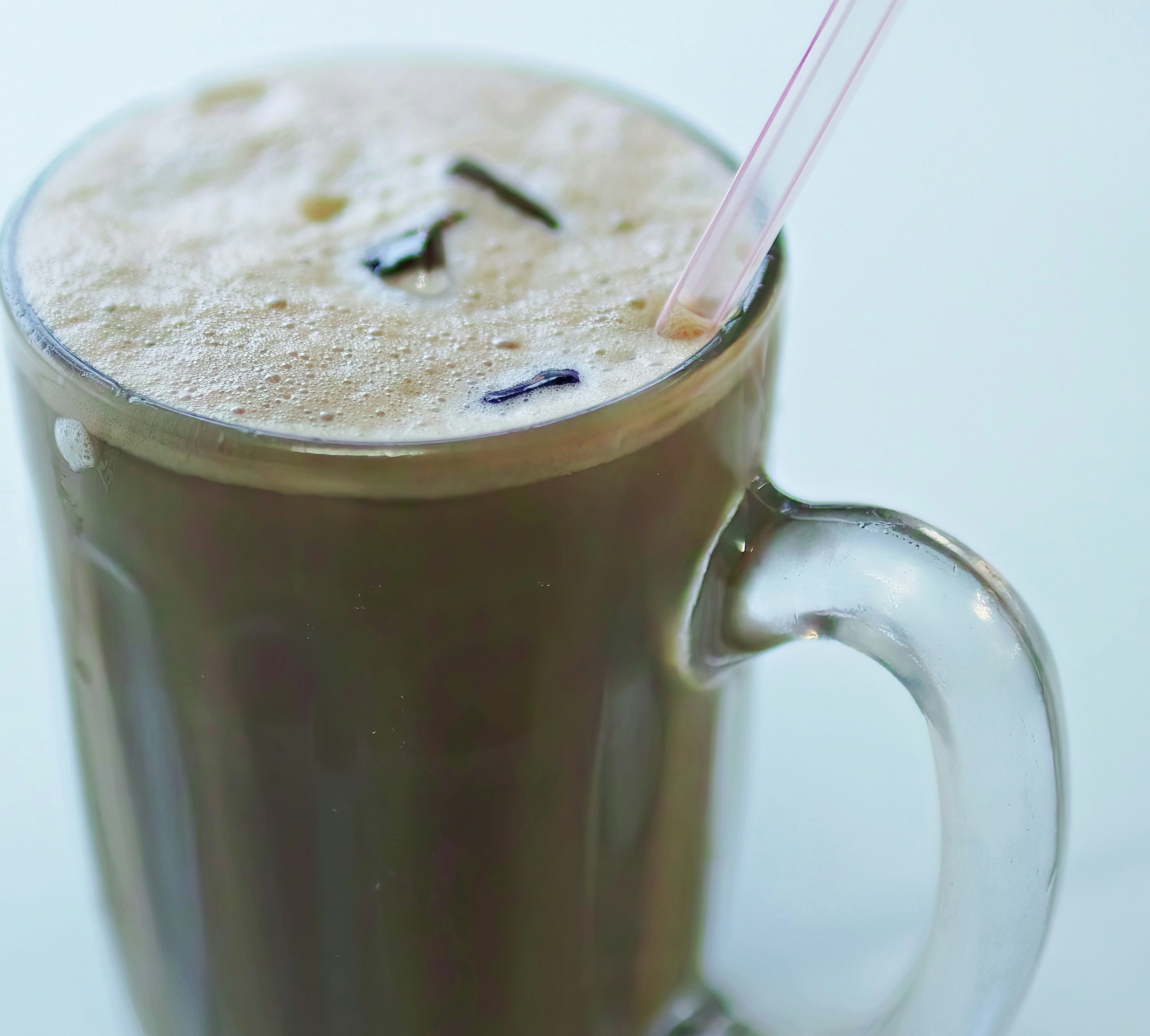 A tall glass of iced tea with a straw