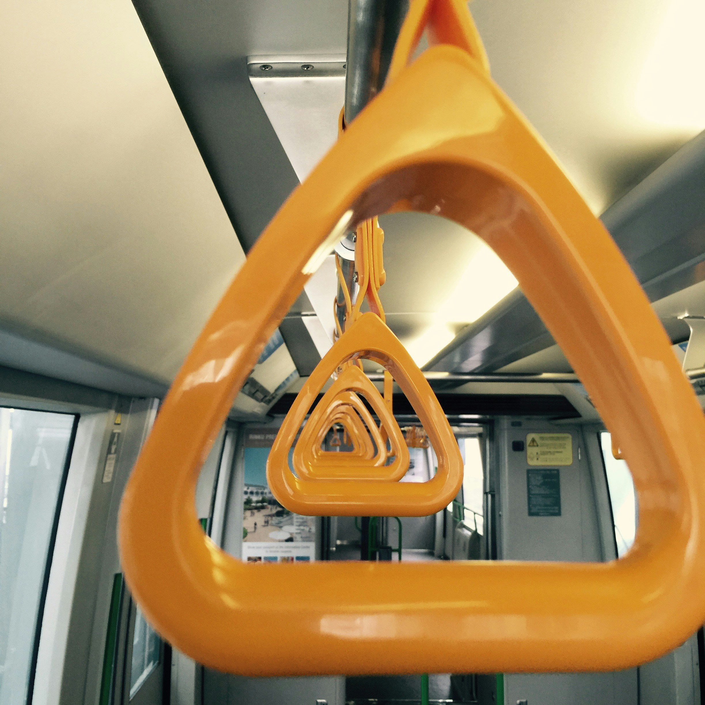 Orange grab handles inside a train