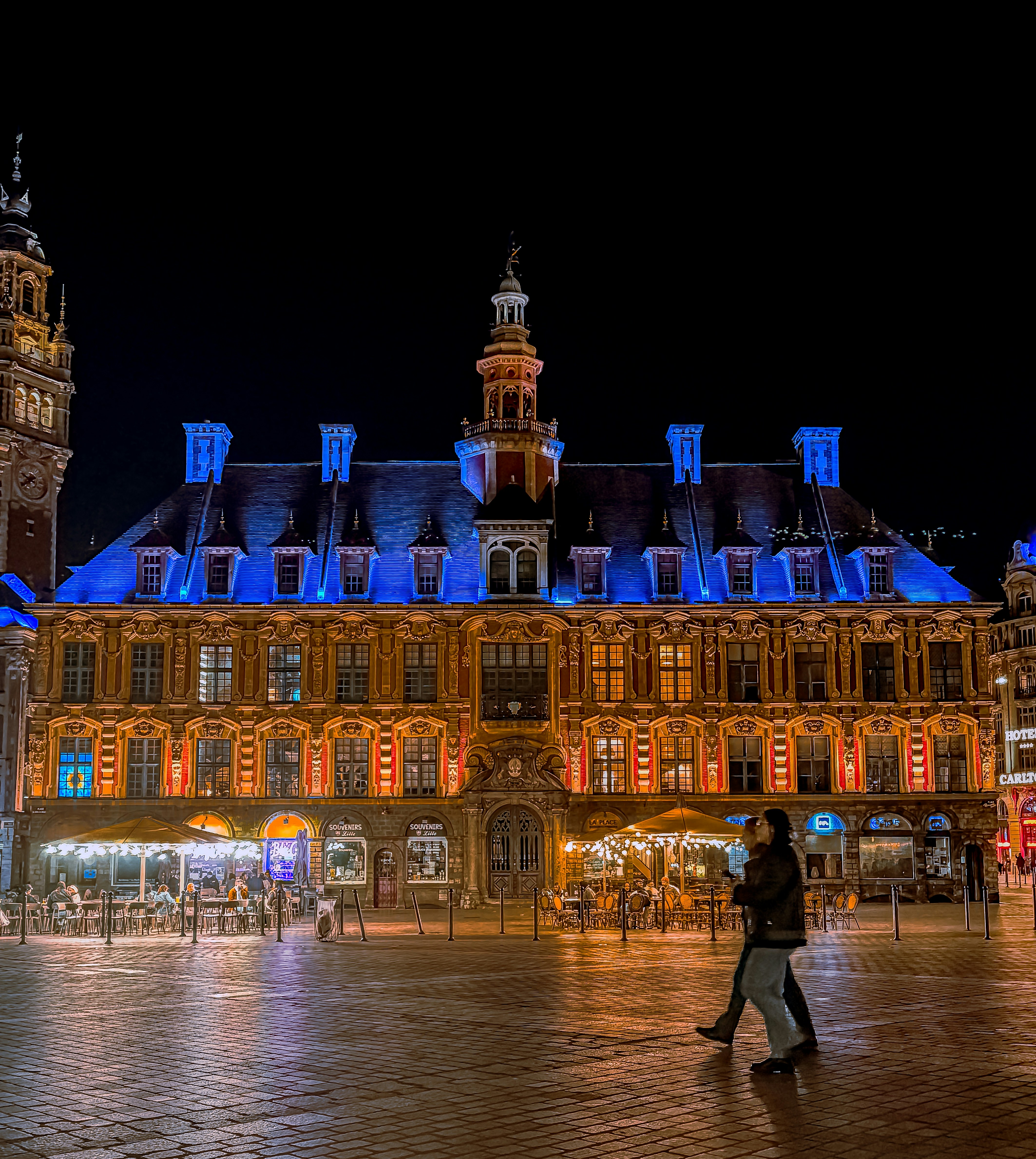 Ornate building illuminated with warm lights at night.