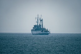 A large ship sails on the open ocean.