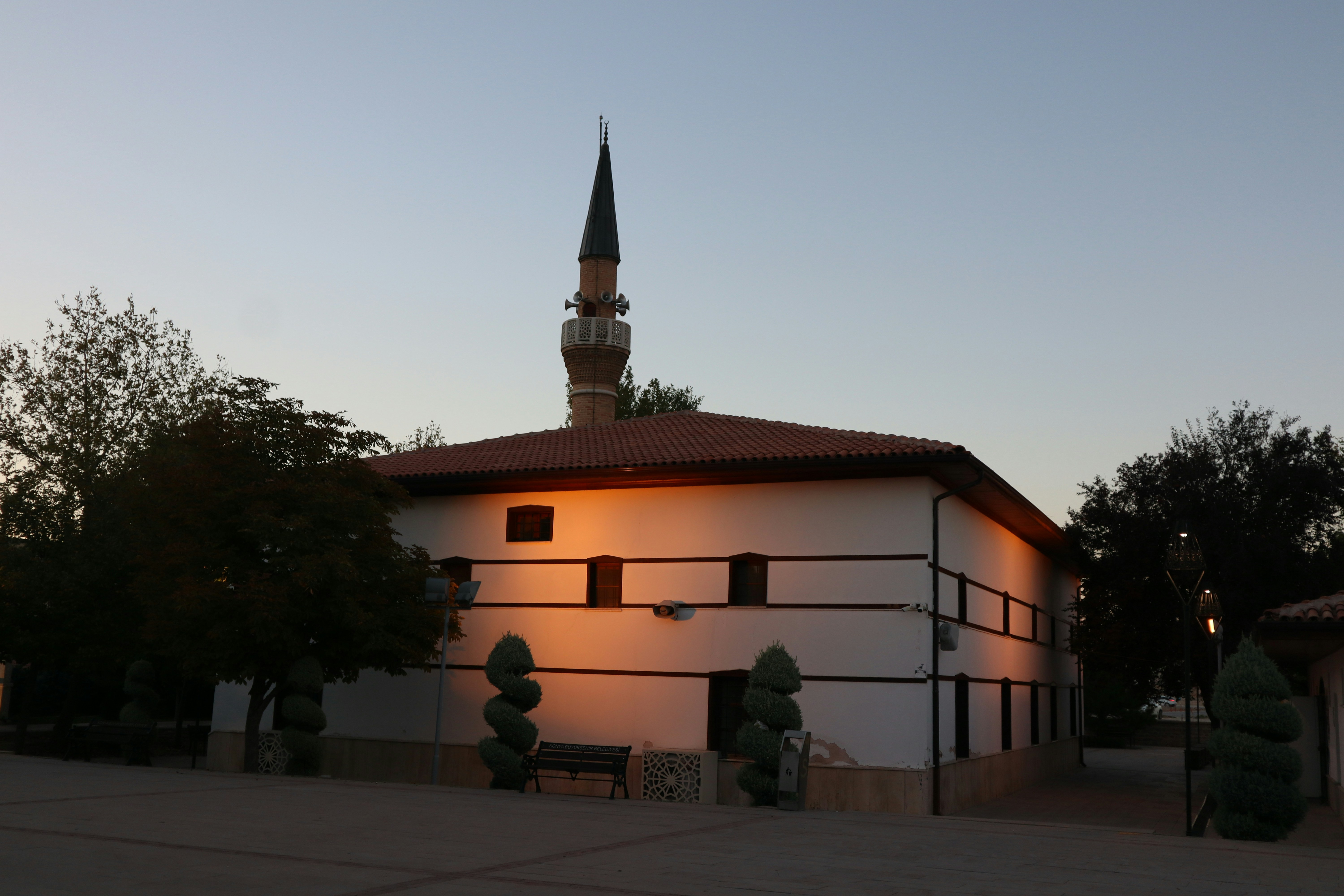 Mosque with minaret at dusk with warm light.
