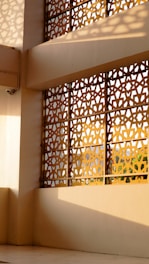 Geometric screen casting shadows on a wall