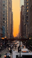 City street with traffic and buildings at sunset