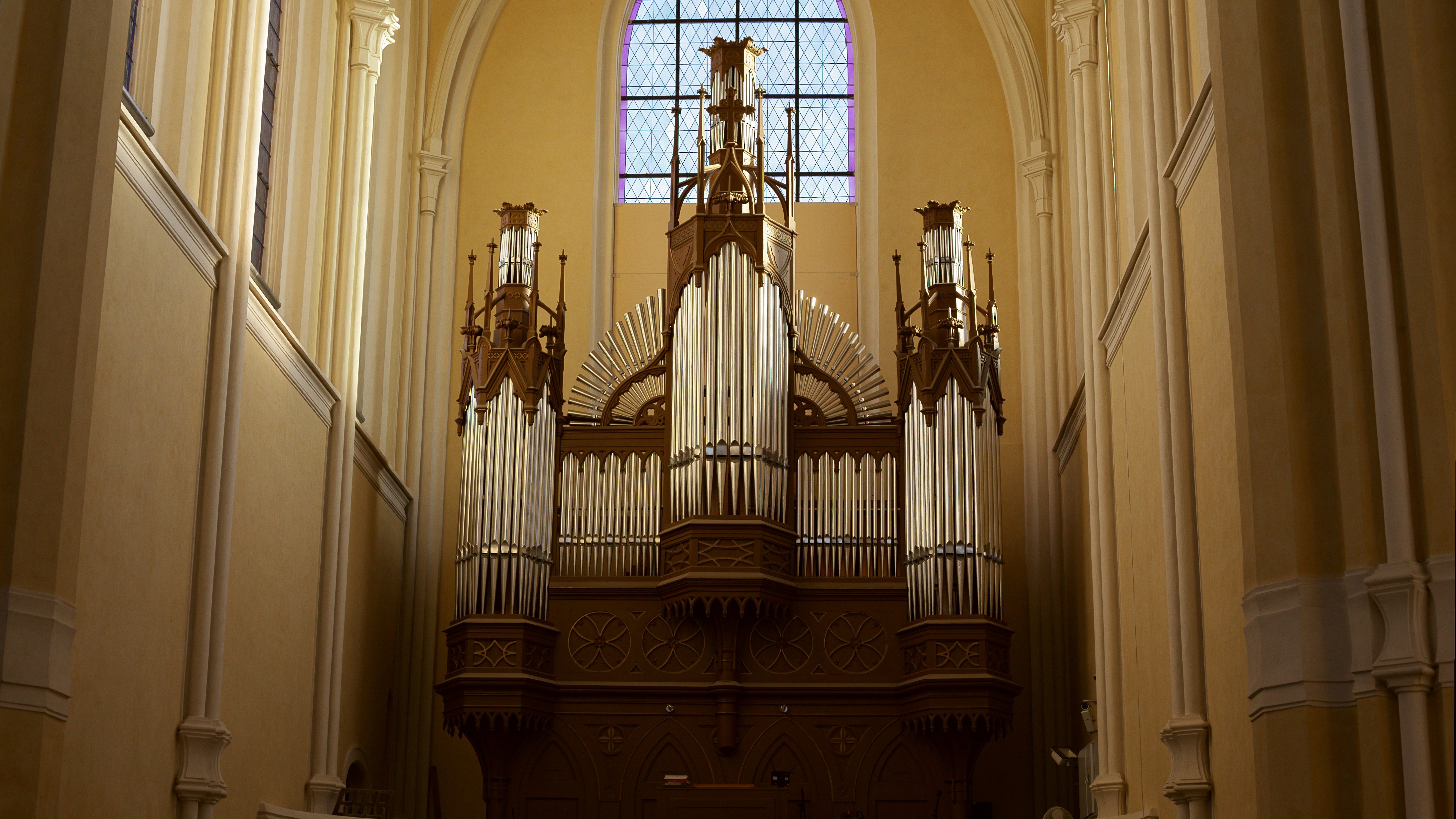 Pipe organ in a church with a tall window