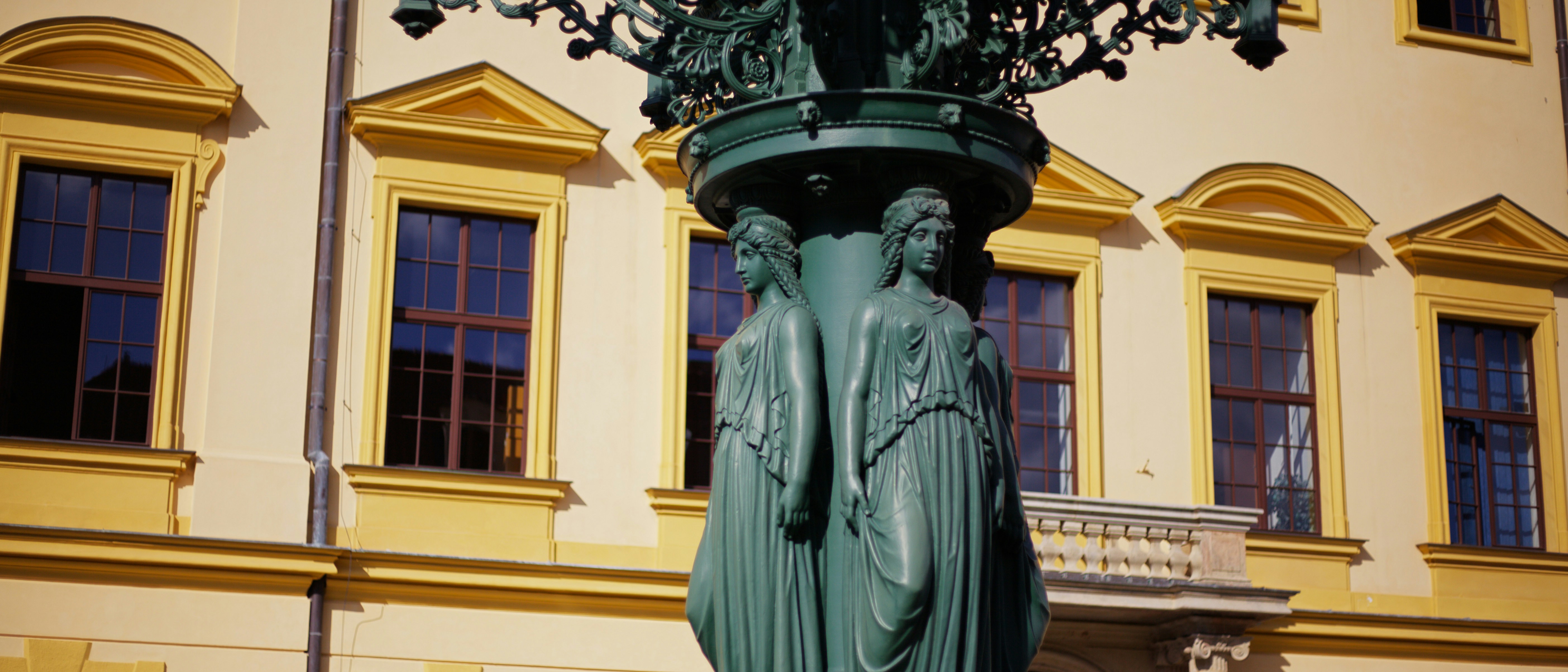 Ornate green statue in front of a building
