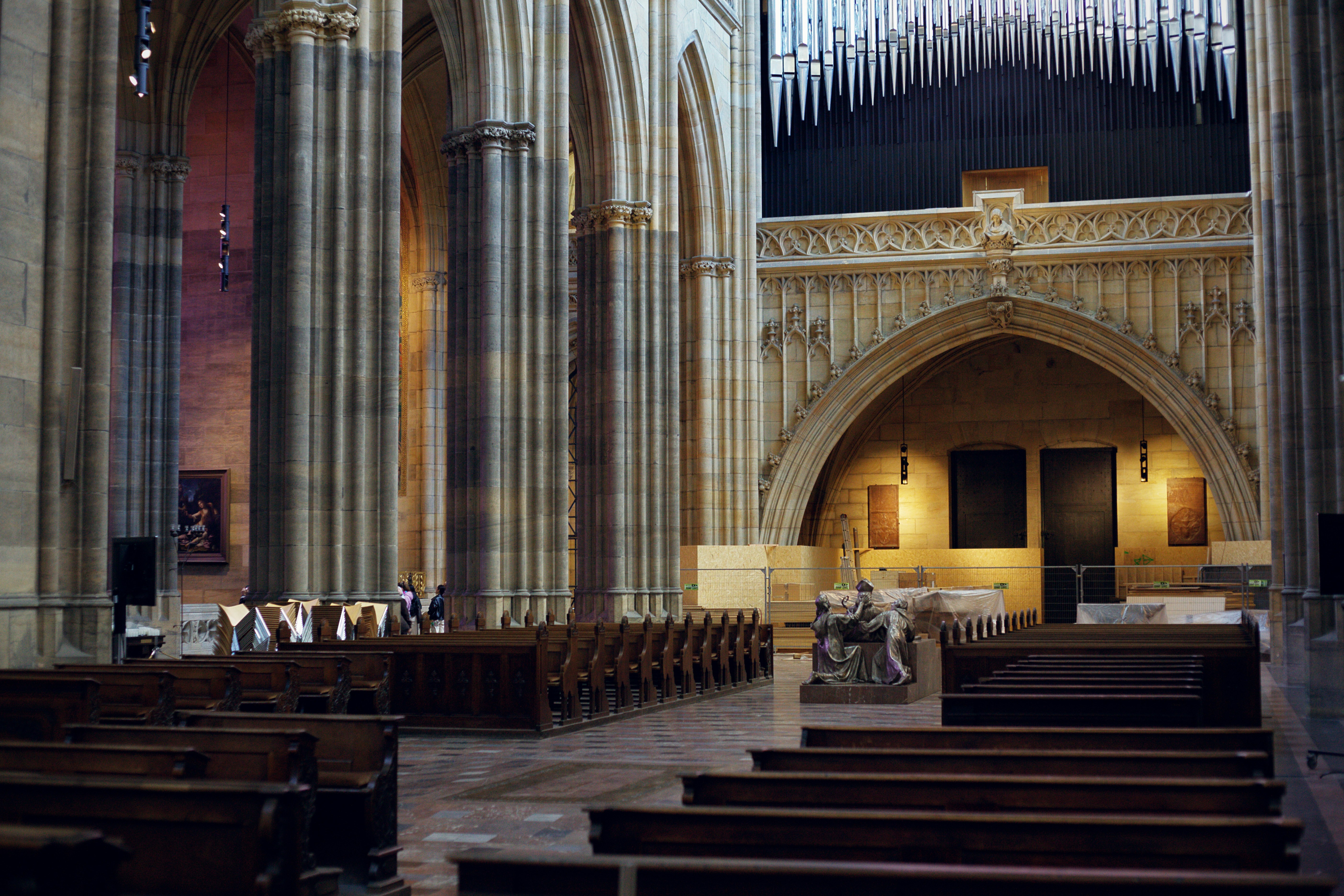 Interior of a grand cathedral with pews and altar.