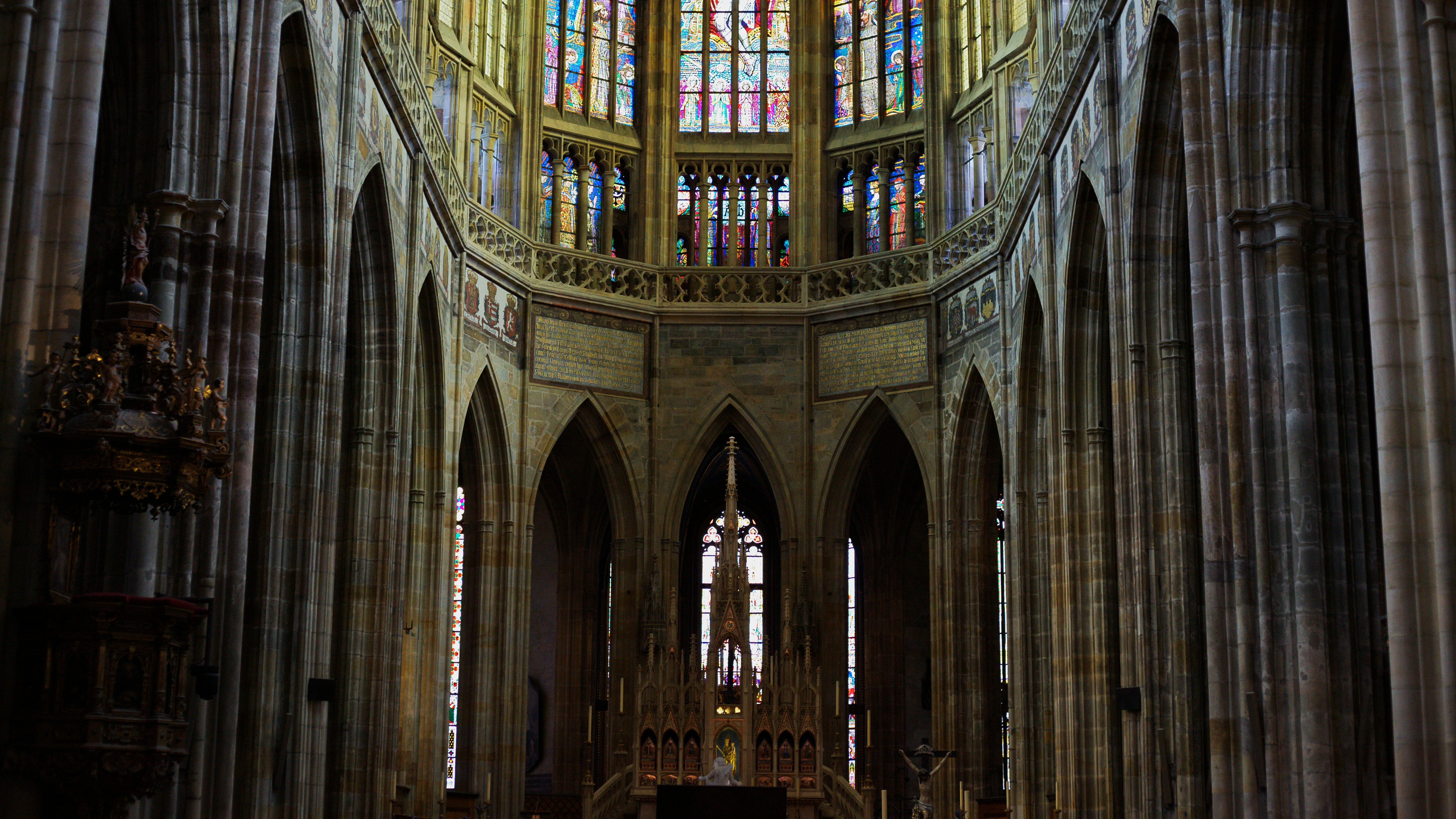 Interior of a grand cathedral with stained glass windows.