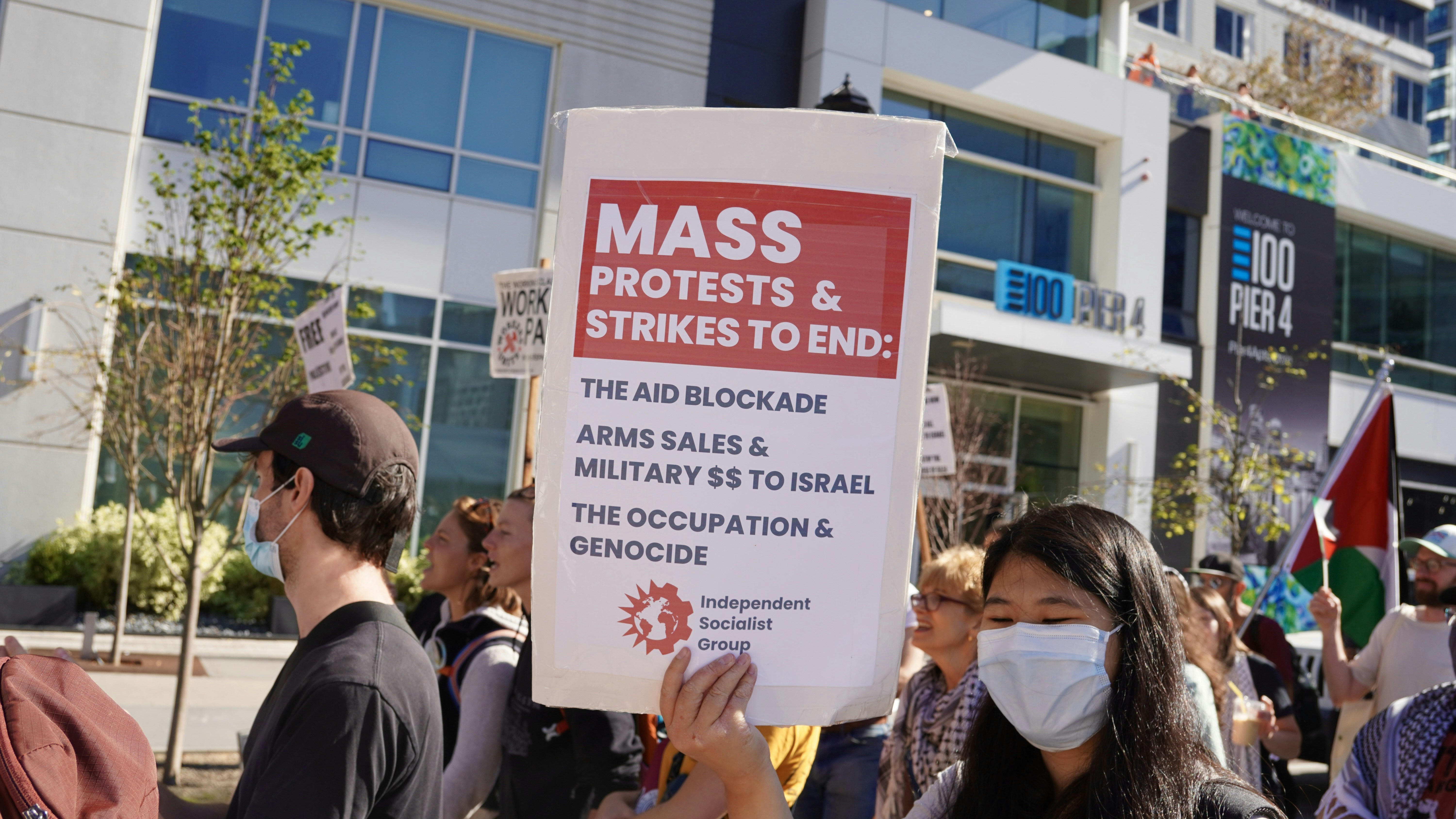 Protesters hold signs at a demonstration