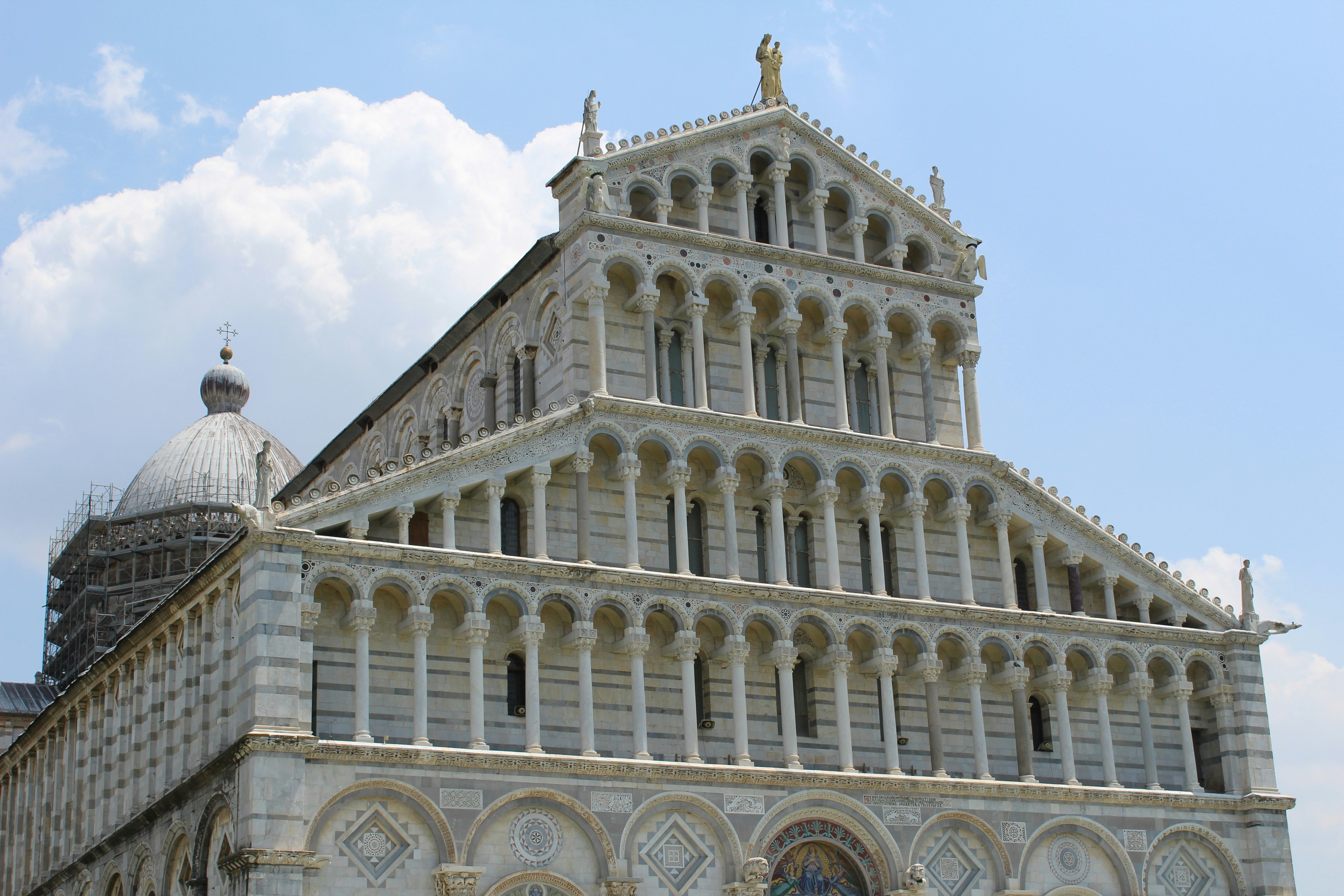 Pisa cathedral with dome against blue sky