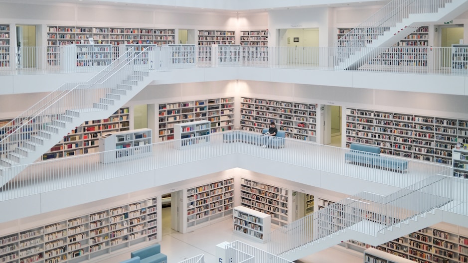 Modern library with bright white shelves and stairs